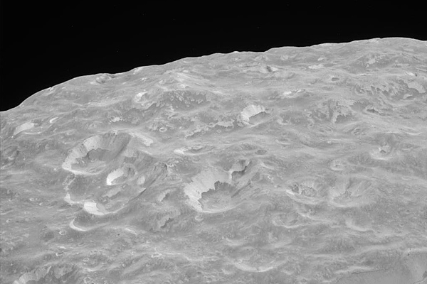 Mimas's limb, showing striking albedo features on crater walls