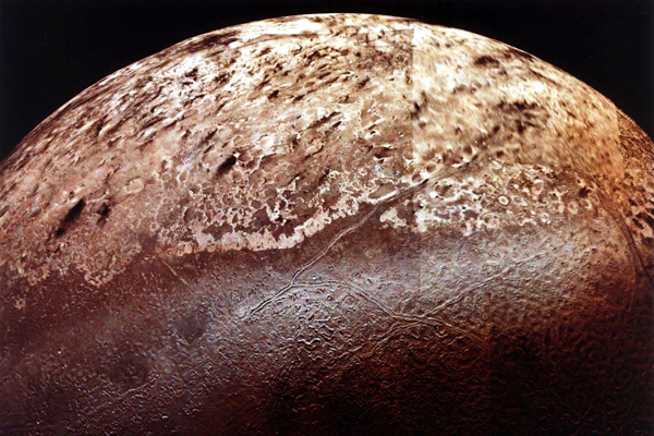 Triton's bright south polar cap above a region of cantaloupe terrain